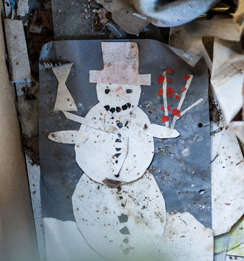 Faded children's drawing of a snowman, Christmas in capitalism