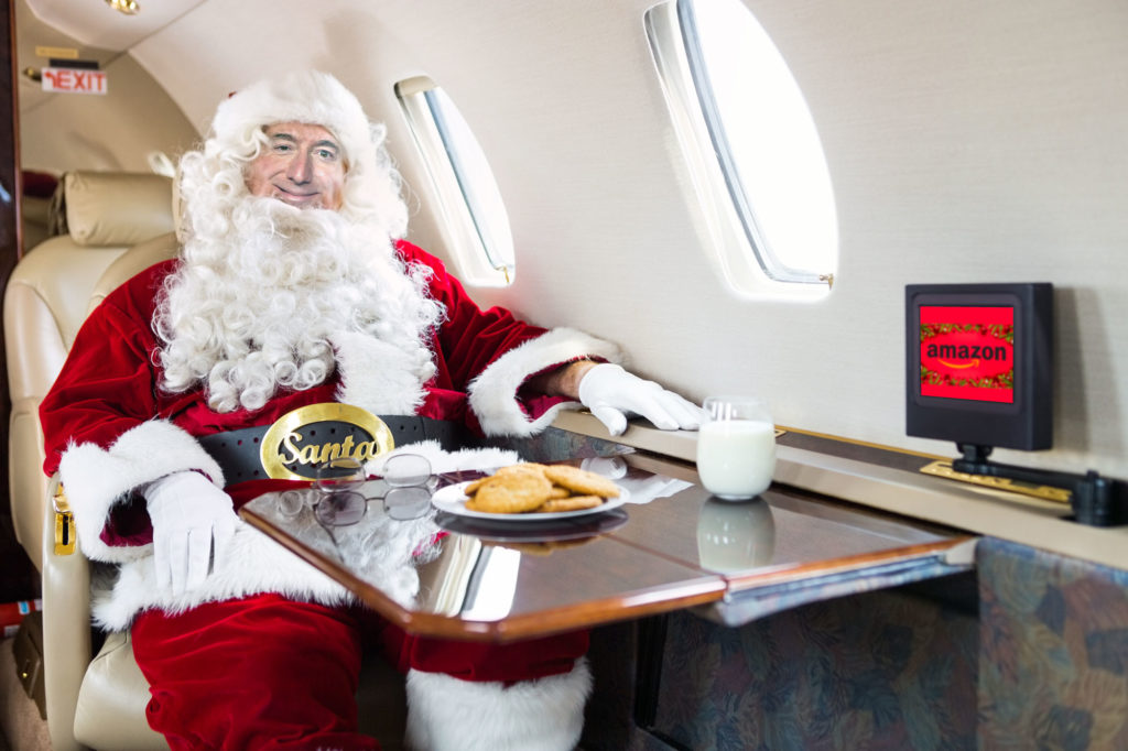 Santa, Patron Saint of Capitalism: Jeff Bezos in Santa Suit in private jet