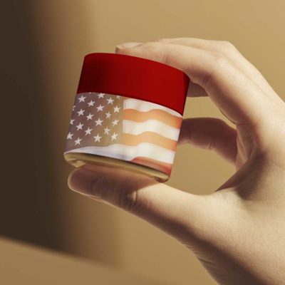 America - The Land of the Free? Do you buy that? Woman holding beauty product with AMerican flag