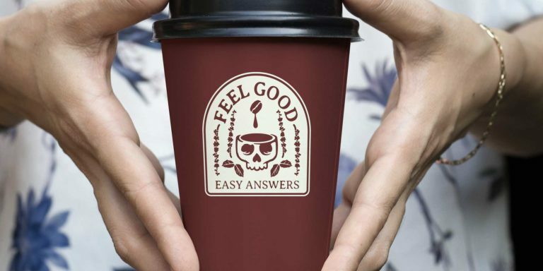 White hands holding coffee to-go cup that with skull logo that reads "Feel good easy answers"